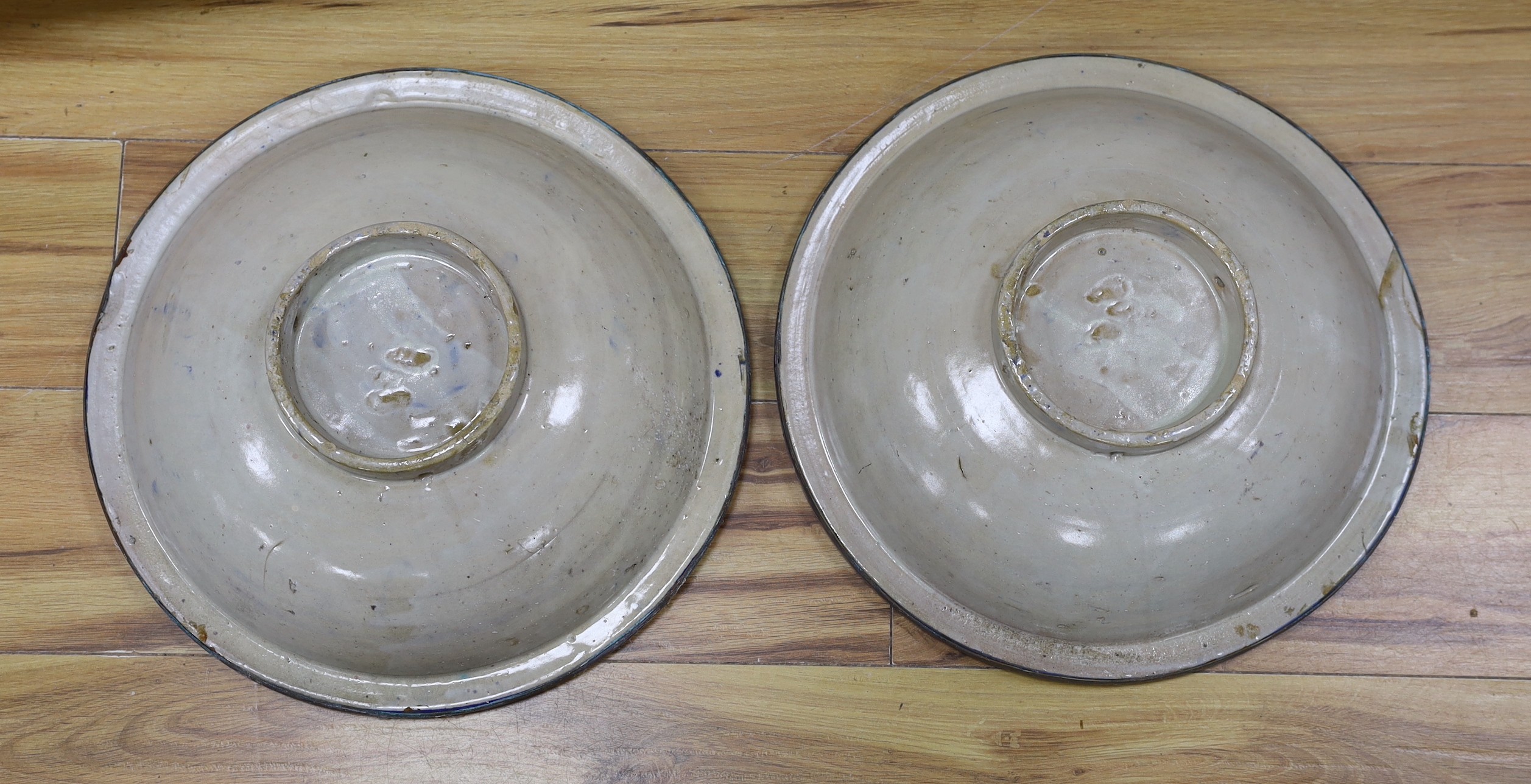 A pair of Moroccan metal bound pottery dishes, 39cm diameter